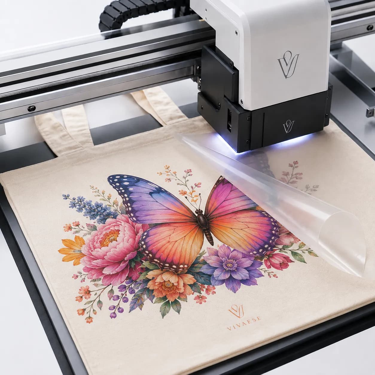 Heat-transfer film being applied to detailed artwork on a natural tote bag