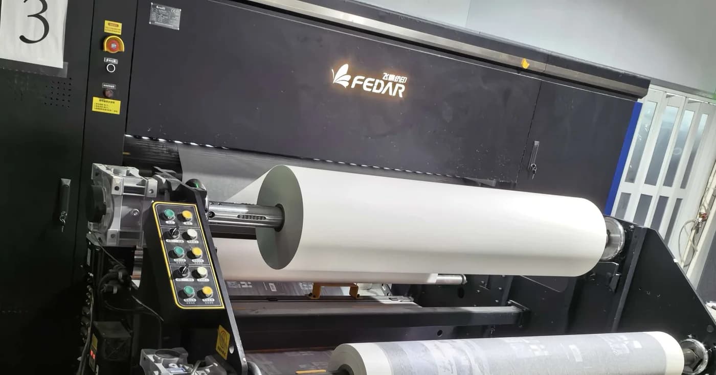 Roll-fed equipment and a material roll at a manufacturing partner facility